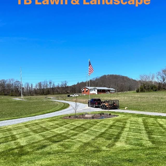 Work truck and trailer on a rural property with fresh mowing stripes